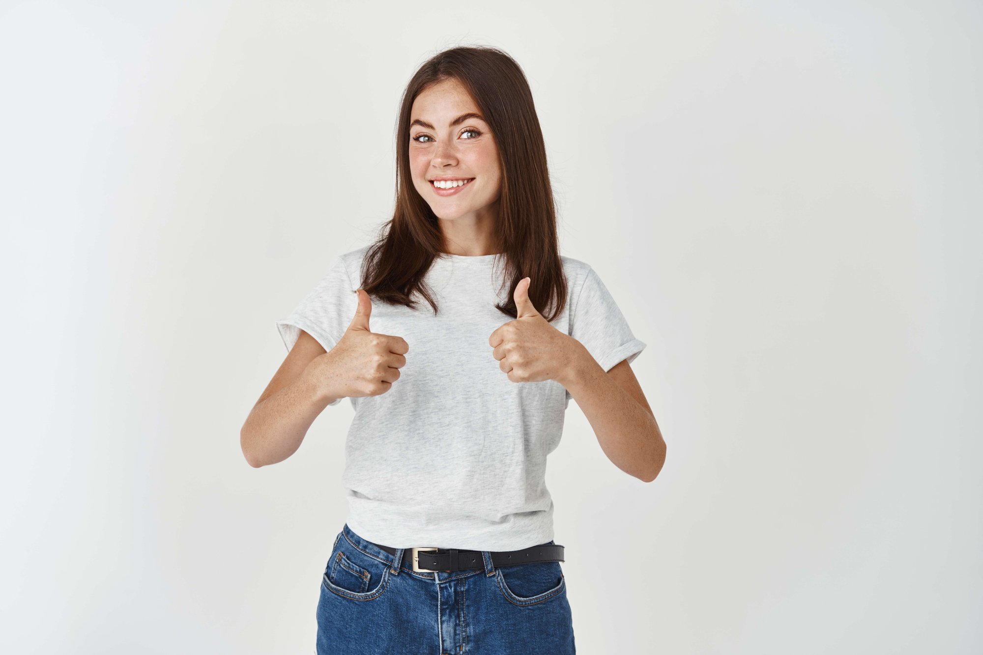 cheerful-woman-saying-yes-showing-thumbs-up-approval-like-agree-with-you-standing-white-wall